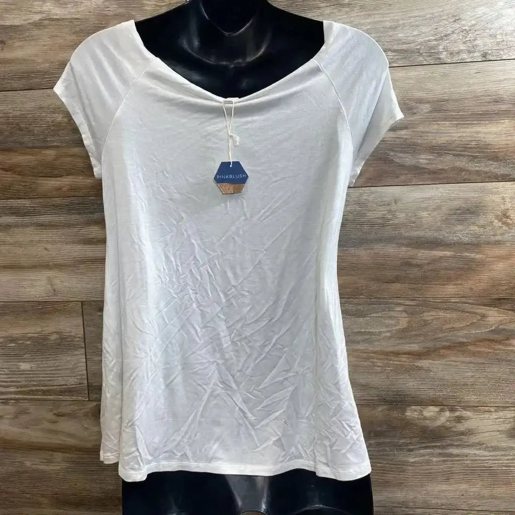 Front view of white maternity short-sleeve scoop-neck shirt showing soft drape and PinkBlush tag on wood plank background