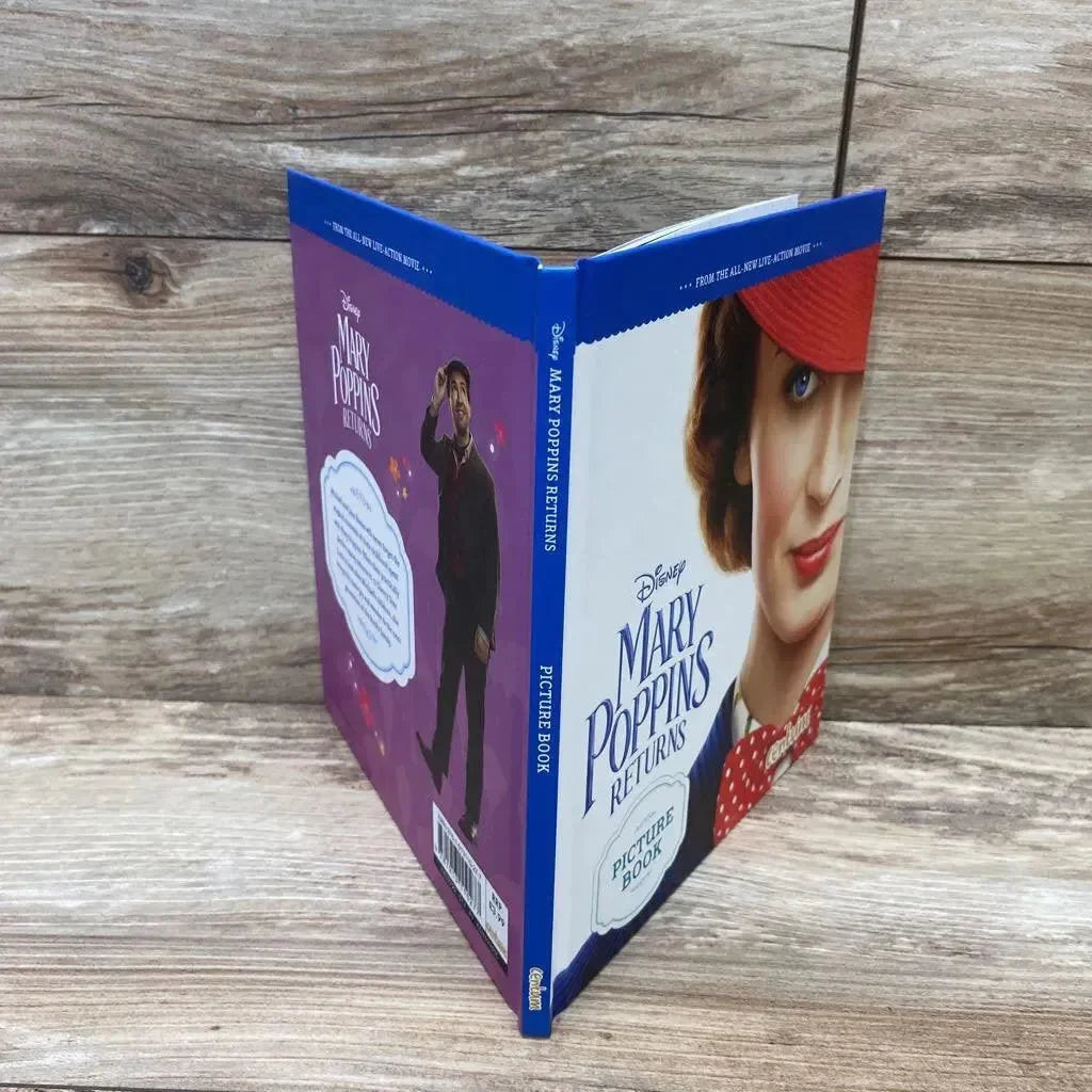 Three-quarter view of Mary Poppins Returns hardcover picture book showcasing front-cover portrait and blue spine on wooden surface