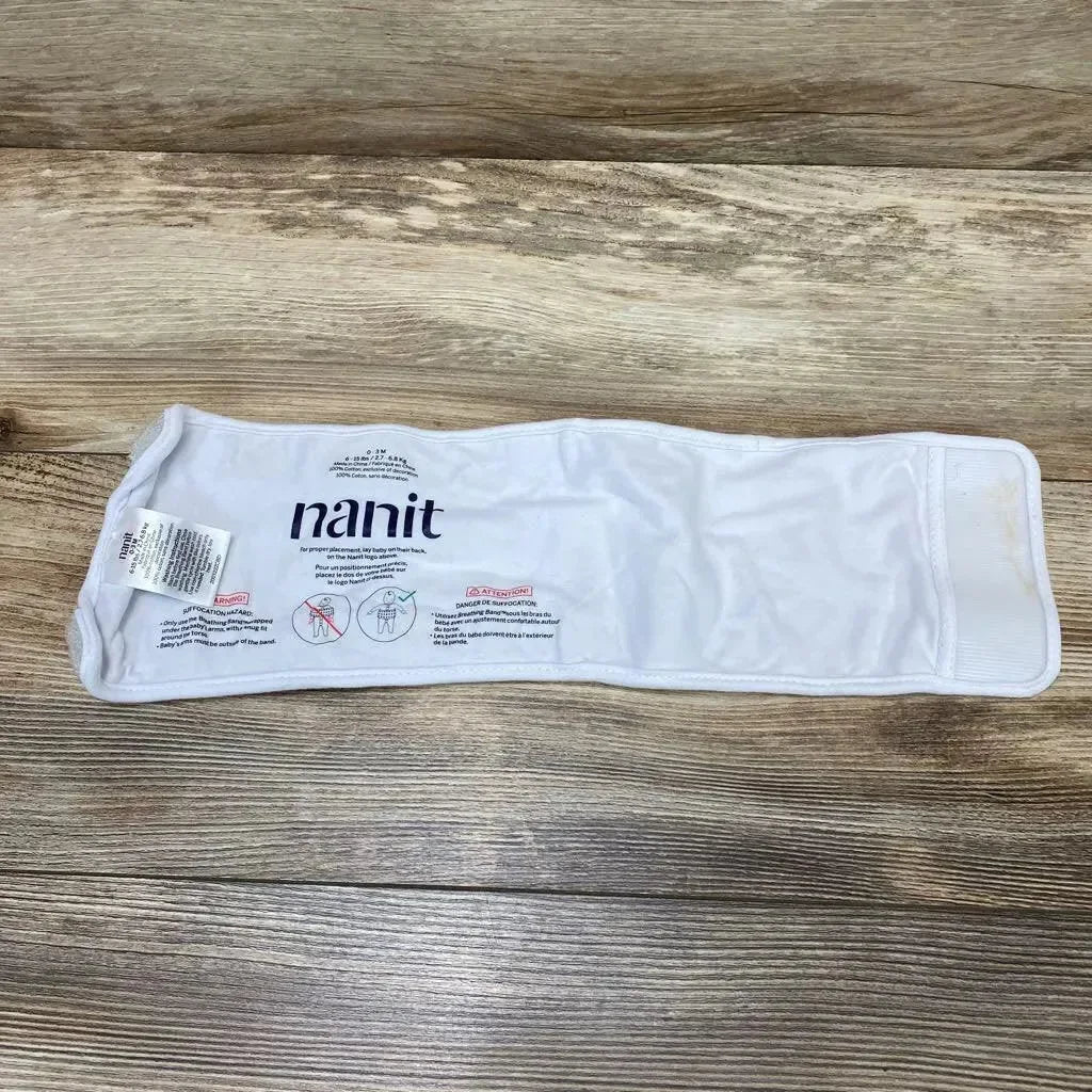 Flat lay of Nanit breathing band wrap size 0-3 months showing Velcro closure and printed Nanit logo on wood background
