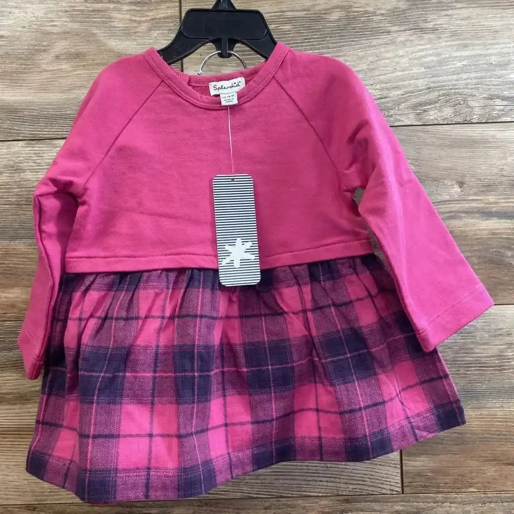 Front view of toddler two-piece set with solid pink long-sleeve top and pink-violet plaid skirt on wooden background