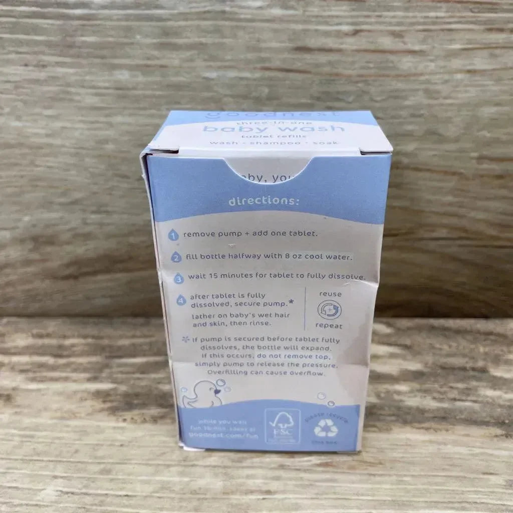 Back view of Goodnest three in one baby wash tablet refills box showcasing blue directions panel and FSC recycle marks on wood plank background