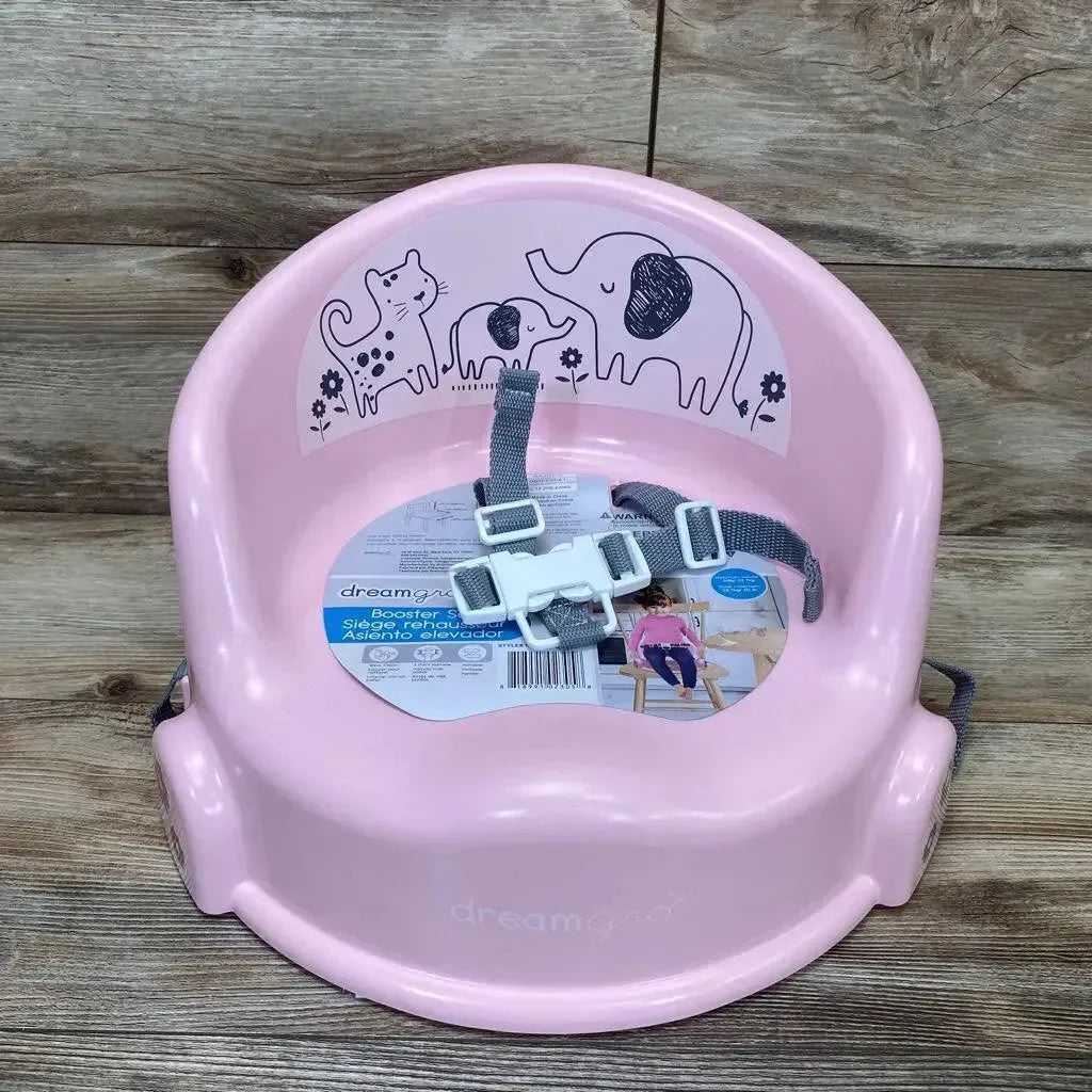 Front view of pink DreamGro Elephant booster seat with gray safety harness and animal print backrest on wood background