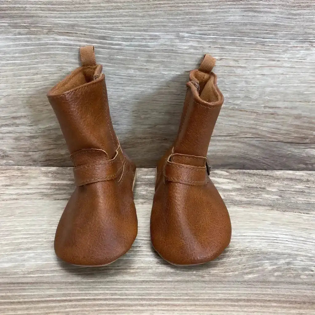 Front view of Old Navy tall buckled booties in cognac faux-leather with pull tabs on wood plank floor