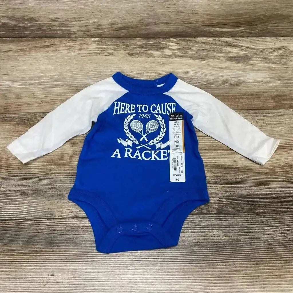 Front view of newborn blue and white long-sleeve bodysuit with Here to Cause a Racket tennis print and snap crotch on wood