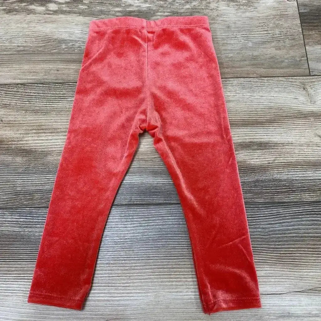 Flat lay of Okie Dokie red velour baby leggings size 12M showcasing soft velour fabric and elastic waistband on wood floor
