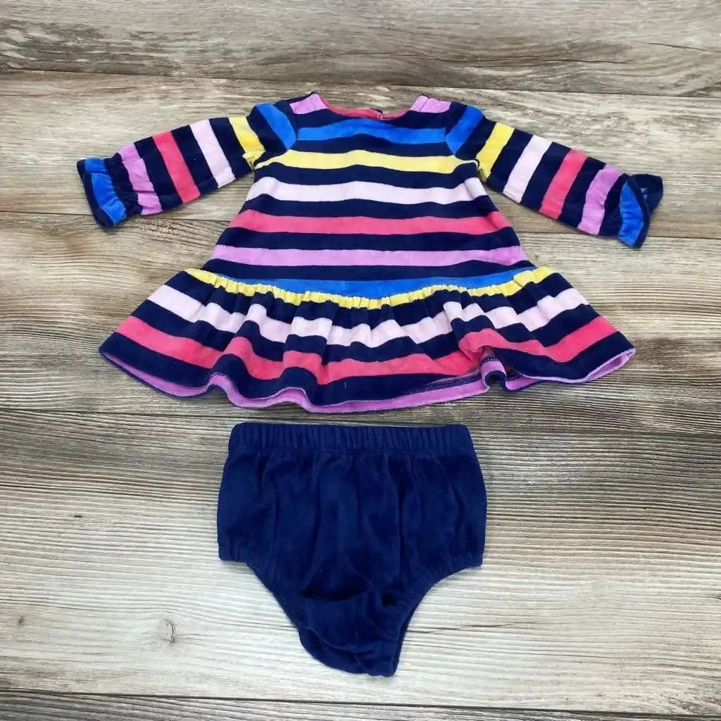 Flat lay of 0-3M striped long-sleeve baby dress with ruffled hem and navy bloomers on wood background