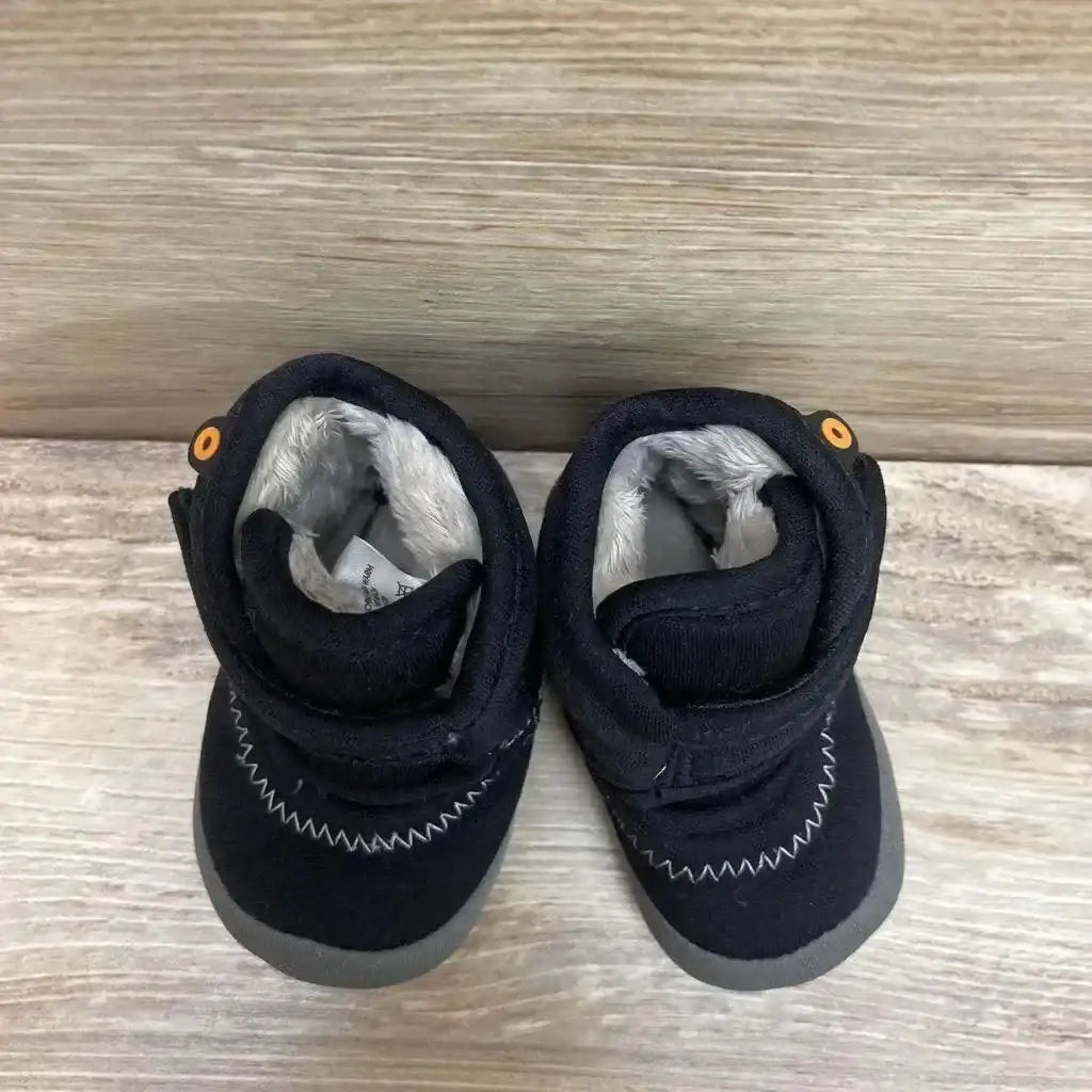 Top-down view of Bogs Elliot II toddler boots showing gray soles, faux fur lining, Velcro straps, and zigzag stitching on wood floor