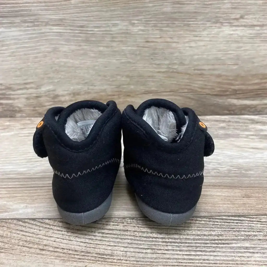 Rear view of Bogs Elliot II toddler black boots showing gray rubber soles and plush gray lining on wood plank background