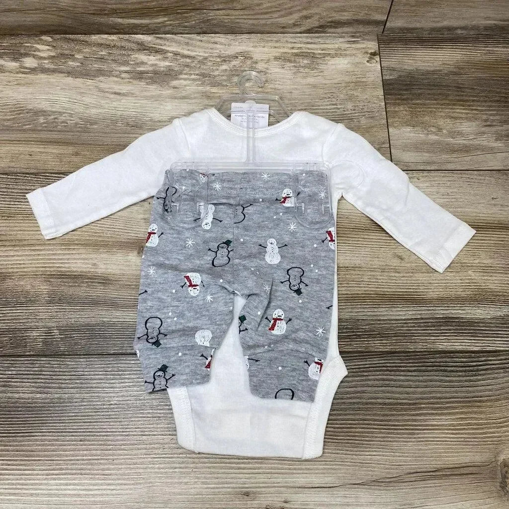 Front view of Just One You 2 piece Snow Much Love set showcasing white bodysuit and grey snowman print pants on wood plank floor