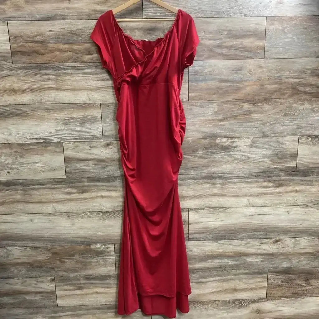 Front view of Pink Blush off shoulder wrap photoshoot dress on hanger showcasing red jersey with ruched side and long skirt on wood plank floor