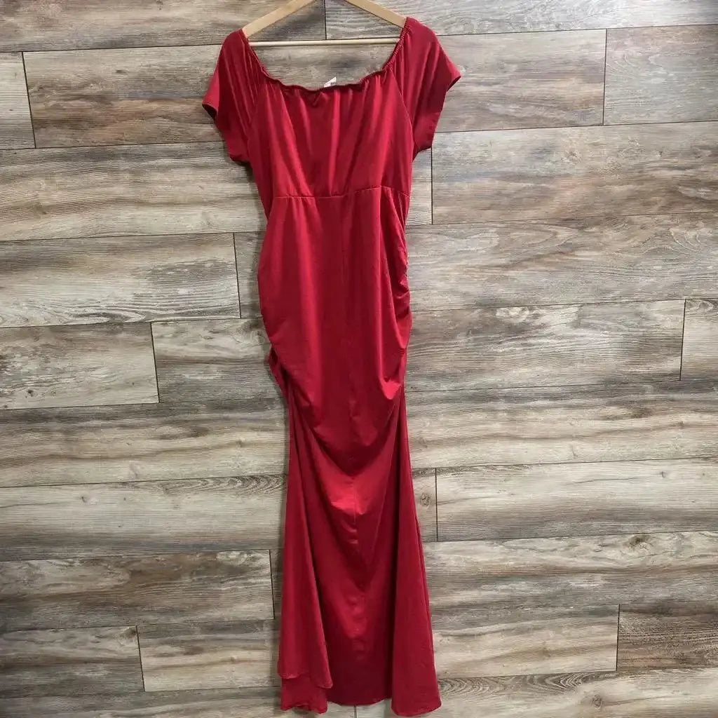 Full-length front view of red off-shoulder wrap dress with ruched sides and short sleeves on a wood-plank wall background