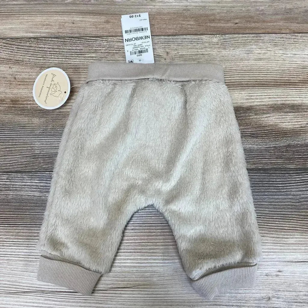 Front view of First Impressions faux sherpa baby pants, tan NB, showing elastic waist and soft texture on white background