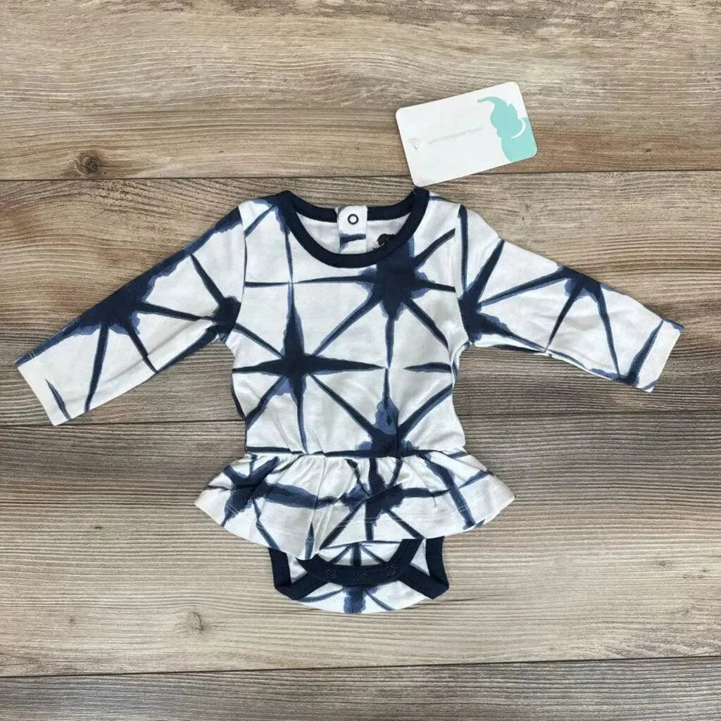 Flat lay of Monica and Andy Shibori Dress Bodysuit sz 0-3m in navy and white tie-dye with peplum skirt and hangtag on wood