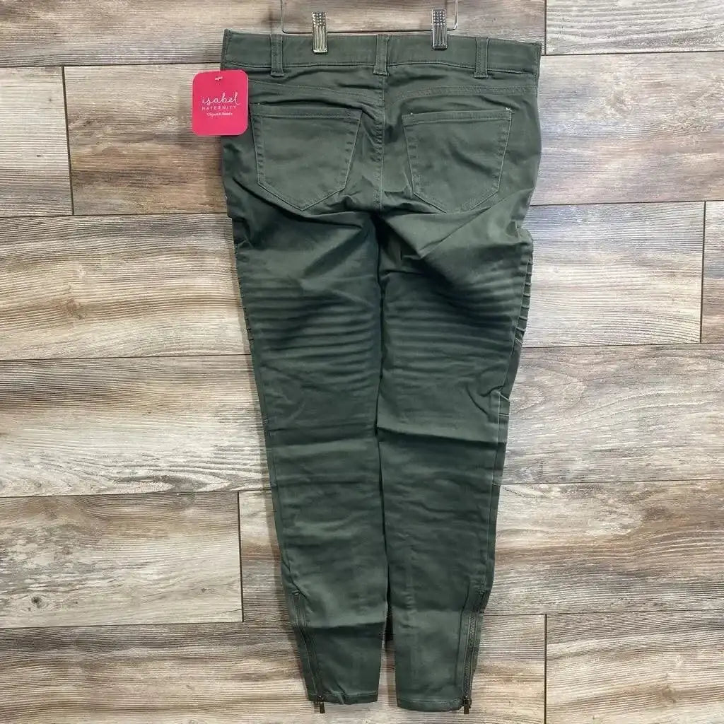Back flat-lay of olive maternity utility jeggings, size 00, showing back pockets, ribbed knee panels and ankle zippers on wood floor
