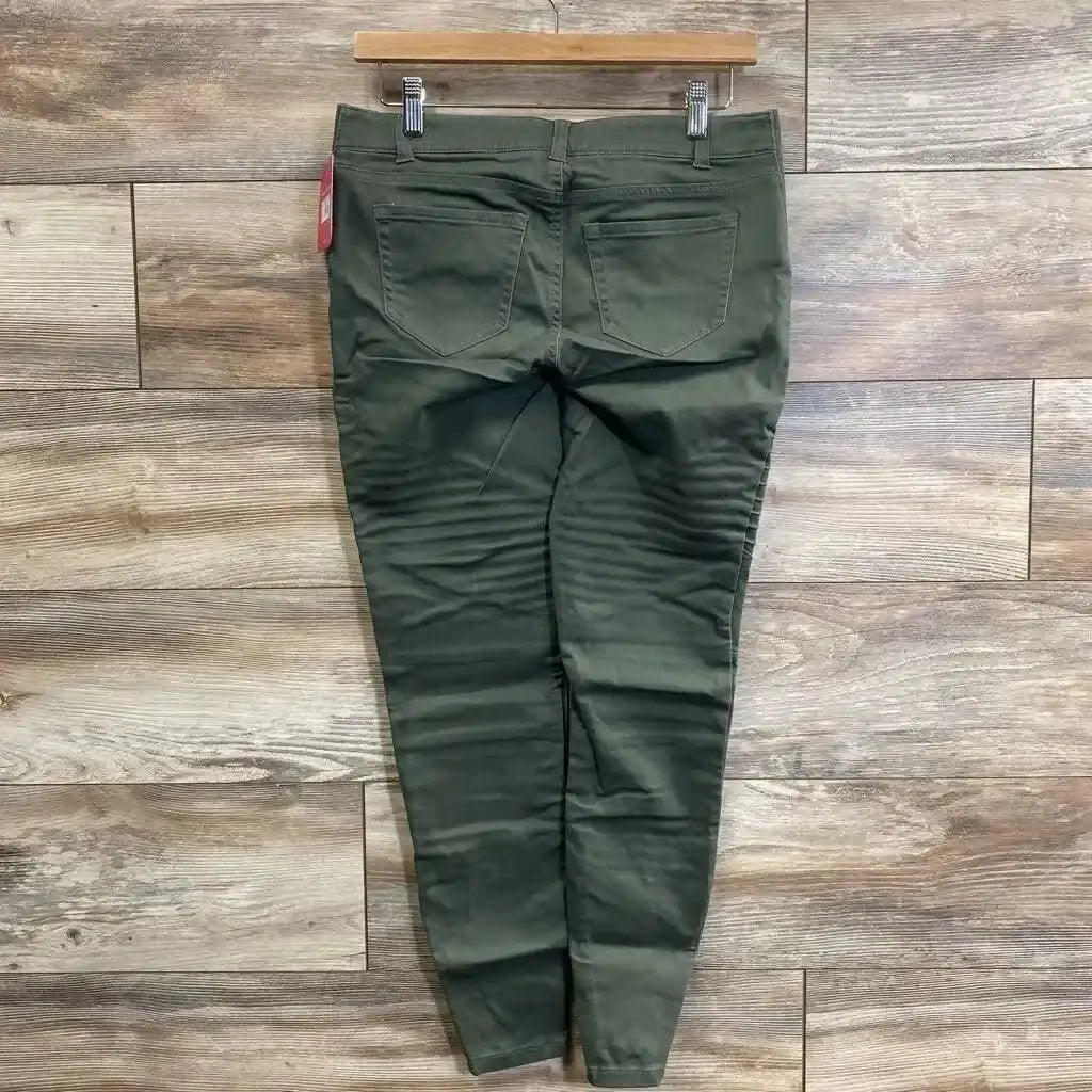 Back view of olive Isabel maternity utility jeggings size 00 showing back pockets and tapered legs on wood plank background