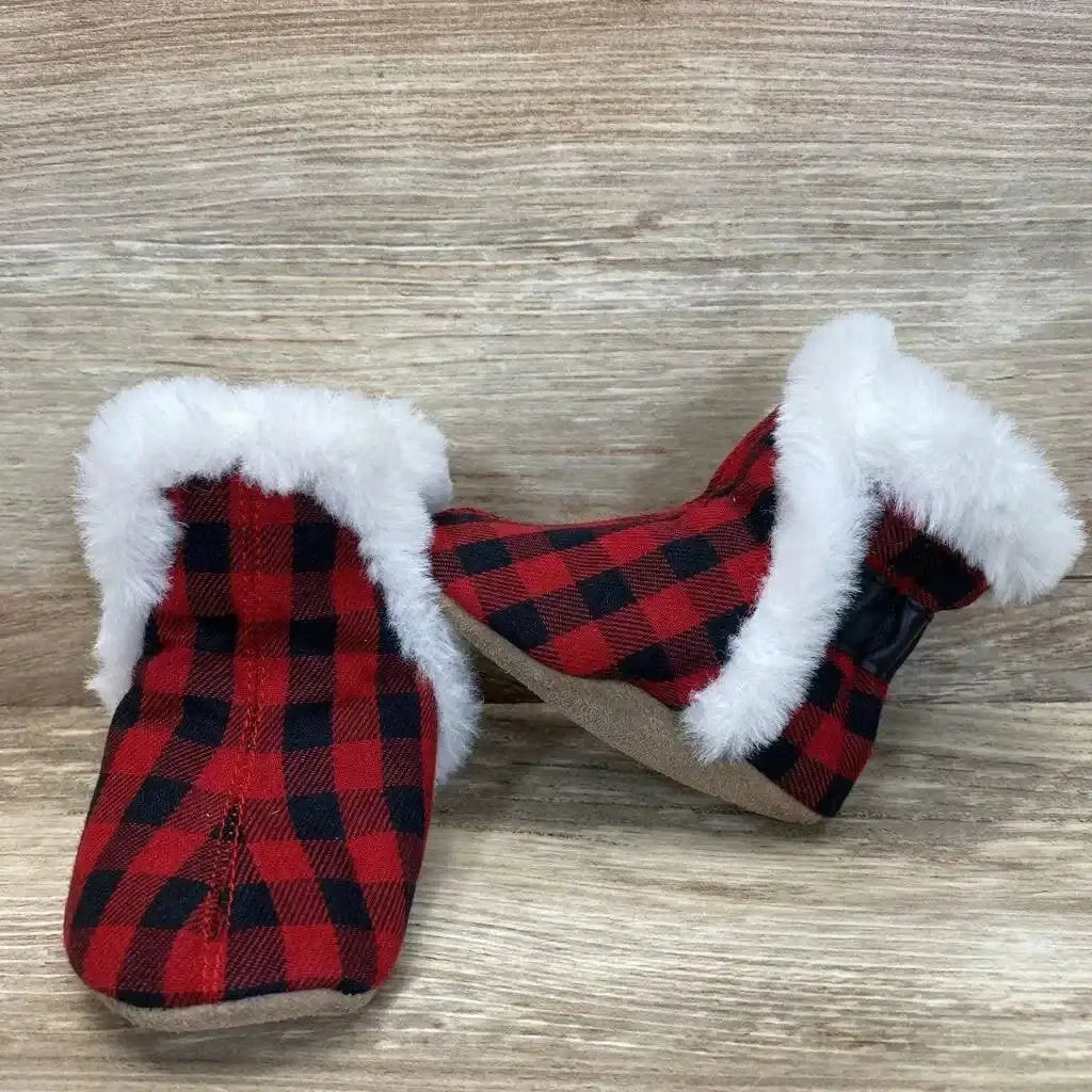 Front and side view of Robeez Jack baby soft sole boots red and black plaid with white faux fur cuffs on wood background