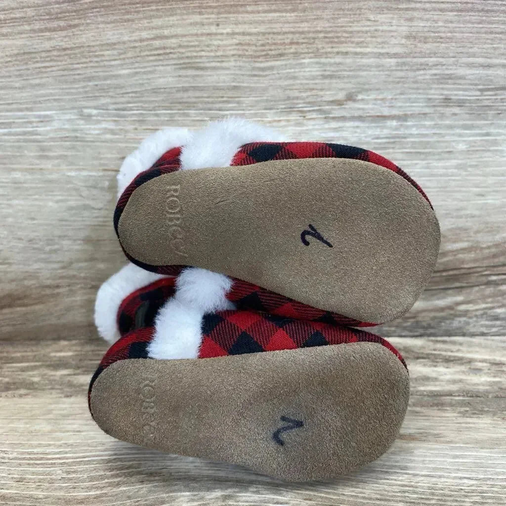 Top view of Robeez baby soft-sole boots in red plaid showing white faux-fur cuffs and suede soles marked 2 on wood background