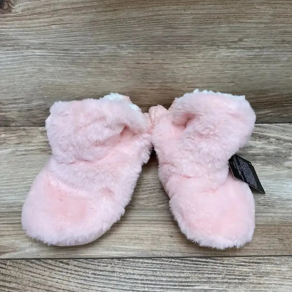 Top view of pink baby gripper slippers size S/M showing plush faux-fur bootie and non-slip soles on wood background