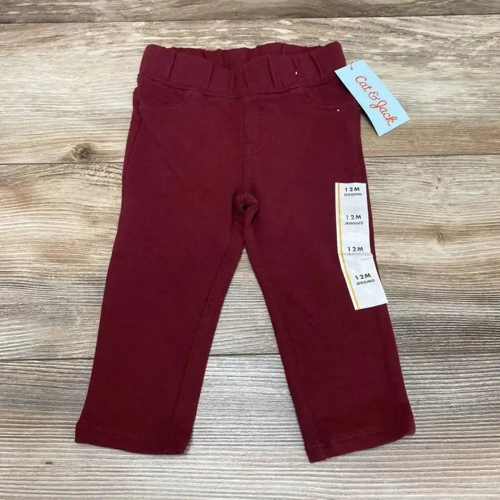 Front view of NEW Cat & Jack Knit Jegging sz 12m showcasing burgundy color and elastic waistband on wood-grain background