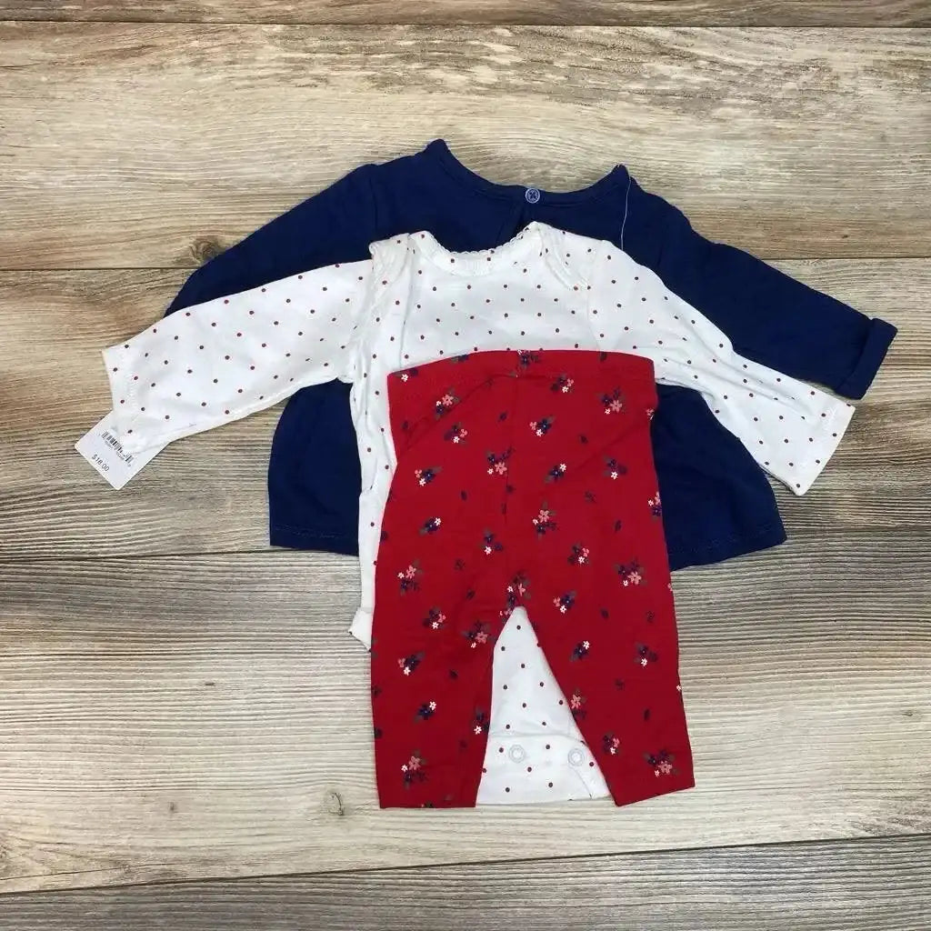 Flat lay of 3-piece set with navy long-sleeve double-knit tunic, white polka-dot bodysuit, and red floral leggings on wood