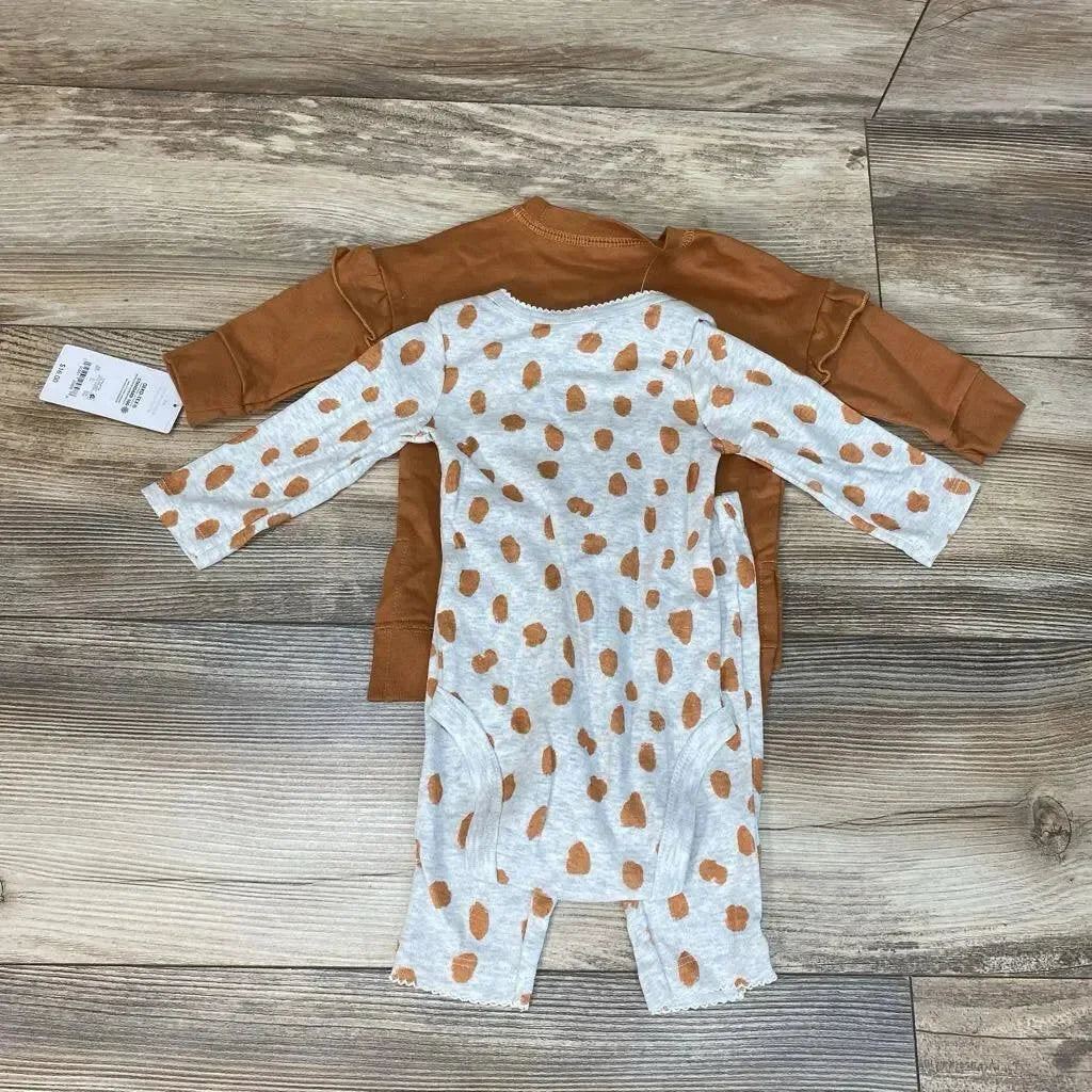 Top view of baby sweatshirt set rust brown crewneck and gray spotted long sleeve bodysuit on wood background