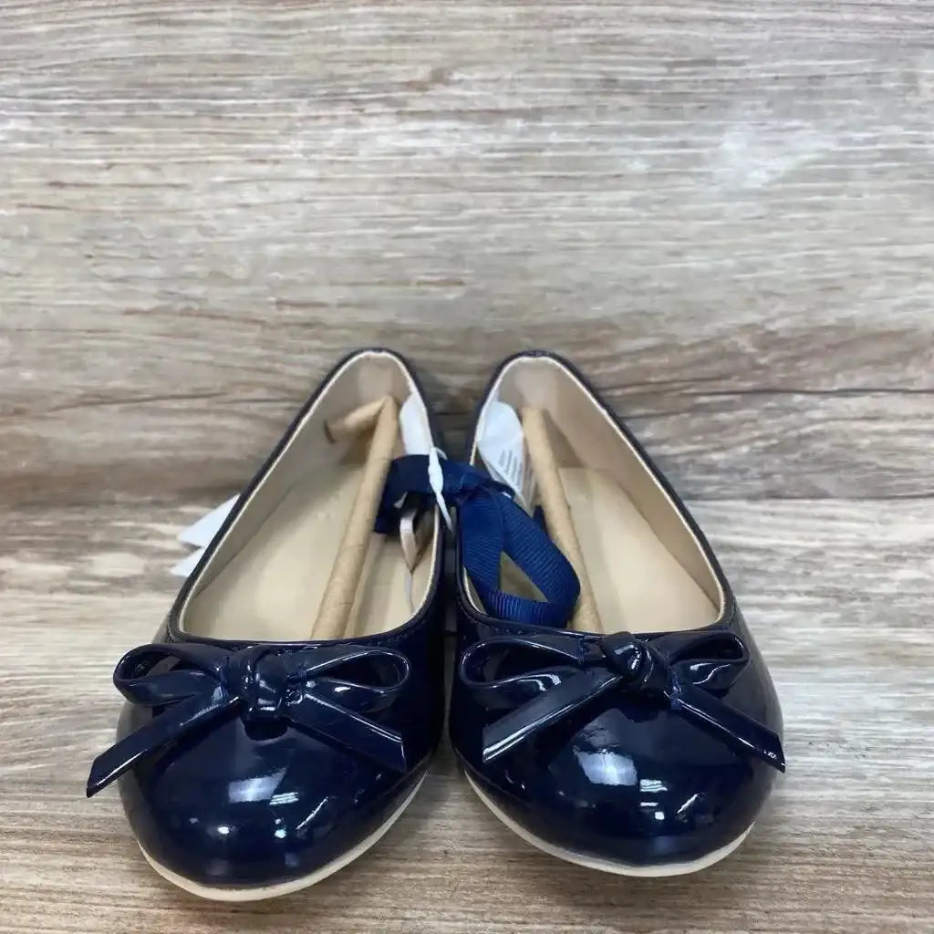 Front view of NEW Janie and Jack patent bow ballet flats sz 9c showcasing navy patent leather with bow toe detail and original tags on wood