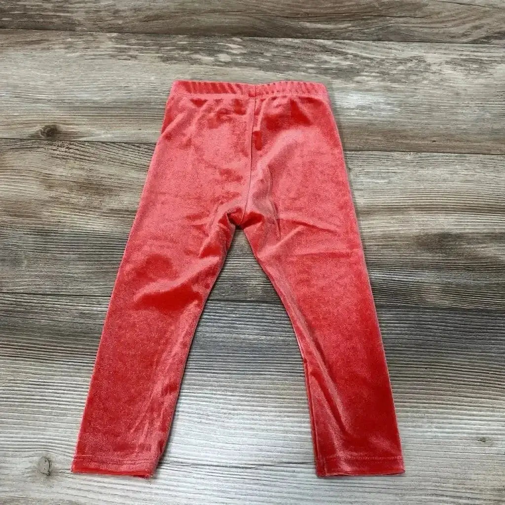 Front view of NEW Okie Dokie velour leggings size 12M showcasing red fabric and elastic waistband on a wood background