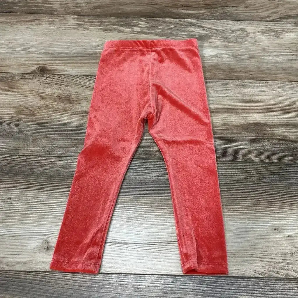 Front view of NEW Okie Dokie Velour Leggings sz 18M showcasing red velour fabric with a wood-grain background