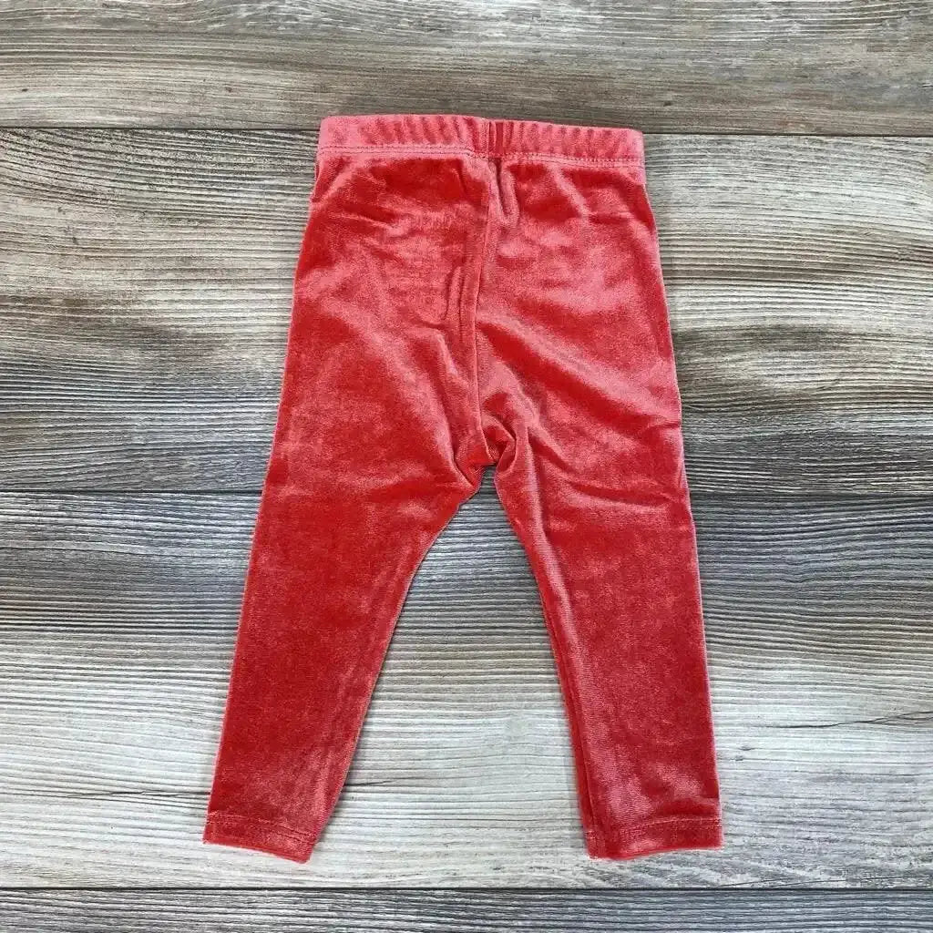 Front view of NEW Okie Dokie velour leggings in size 6M showcasing red velour fabric and elastic waistband on a gray wood-grain background