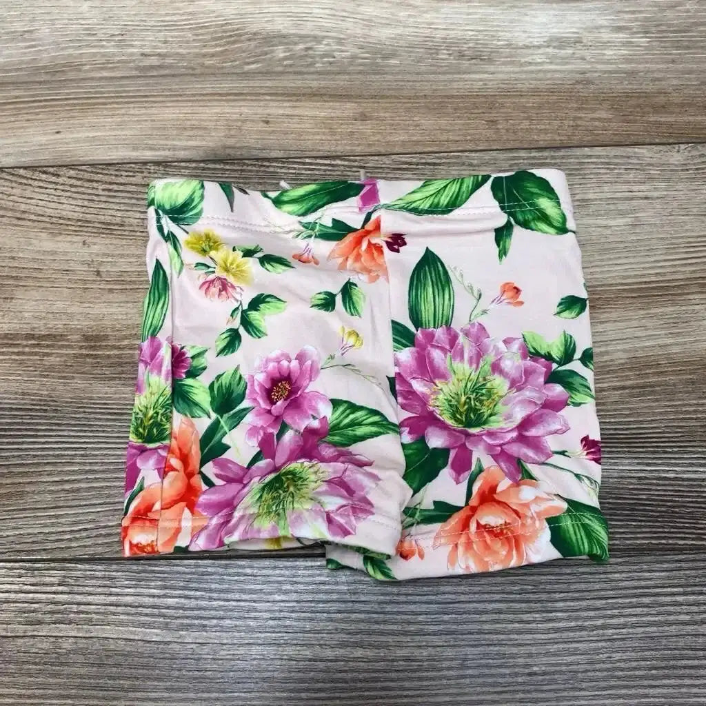 Front view of pink floral Janie & Jack baby swim shorts, 6-12 months, showing elastic waistband and ruffle trim on white background