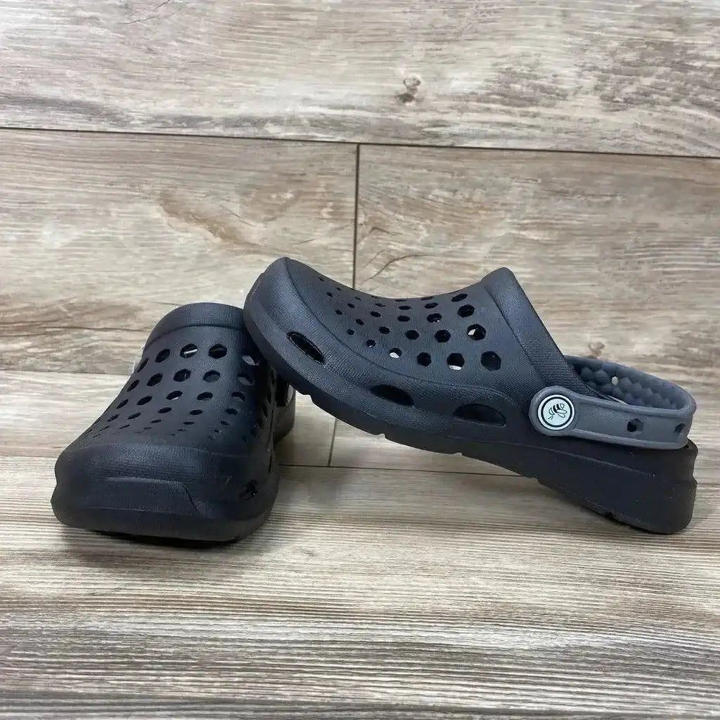 Three-quarter view of black Joybees toddler clogs, size 2Y, showing perforations and heel strap on wood floor