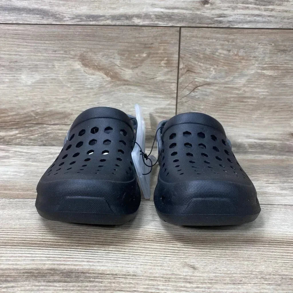 Front view of a pair of black Joybees unisex varsity clogs size 2Y showcasing perforated upper and heel strap on wood plank background