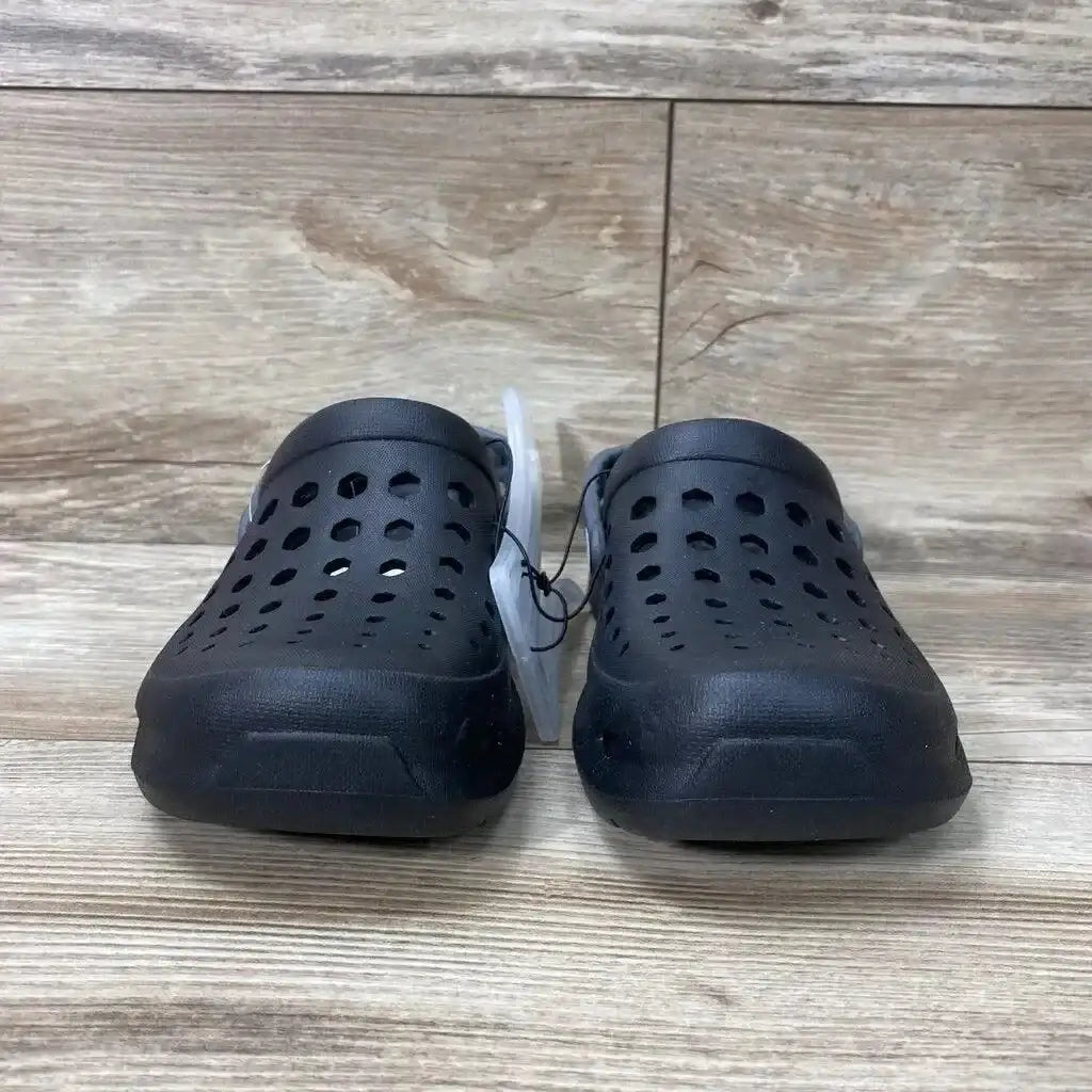 Front view of a pair of black Joybees unisex varsity clogs size 2Y showcasing perforated upper and heel strap on wood plank background
