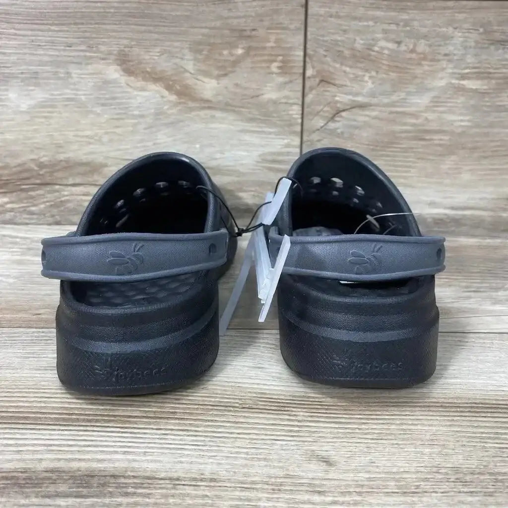 Rear view of toddler black Joybees varsity clogs showing heel straps, textured footbeds, and size 2Y tags on wood floor