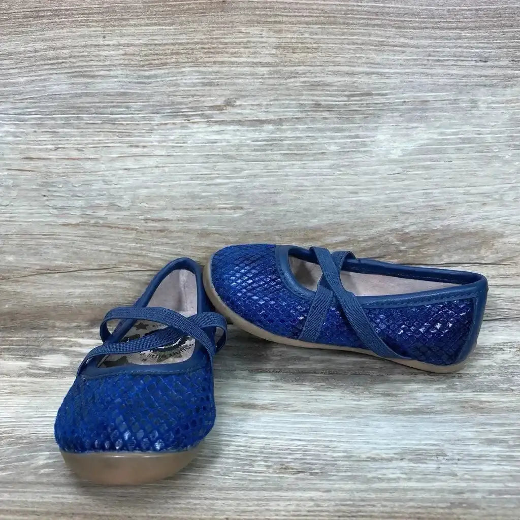 Angled view of Livie and Luca blue ballet flats size 4C with textured metallic upper and elastic cross straps on light wood