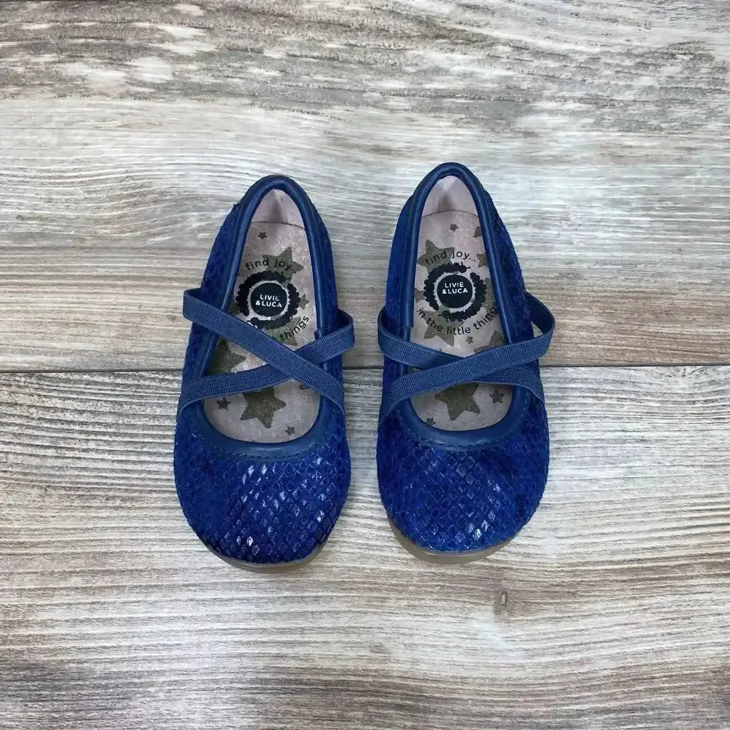 Top view of blue Livie and Luca ballet flats size 4C with sparkly texture and crisscross straps on wood floor