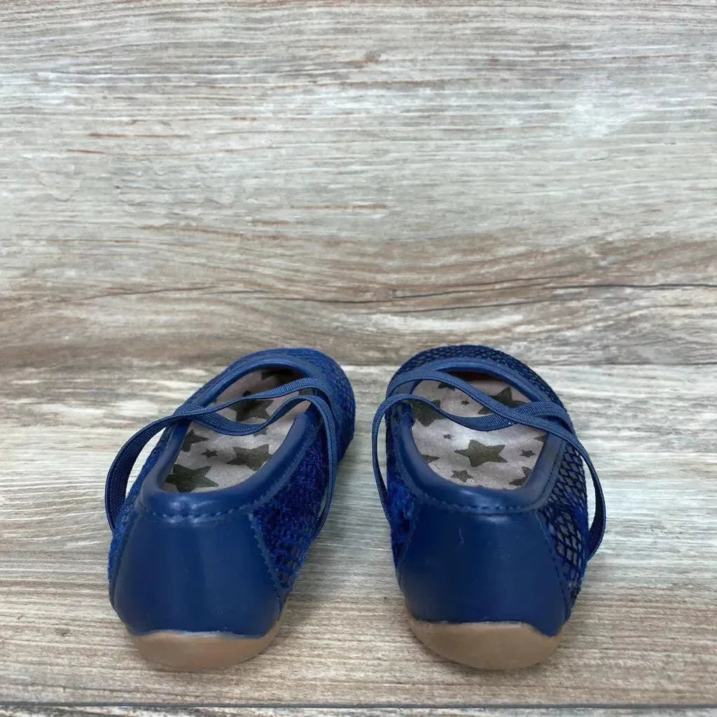 Rear view of blue toddler Livie & Luca ballet flats showing star-printed insoles and elastic straps on wood grain background