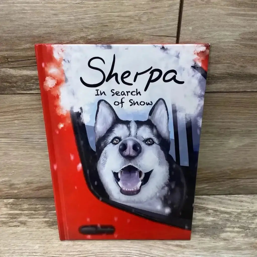 Front cover of Sherpa: In Search of Snow hardcover showcasing a smiling husky poking from a red car window with wood background