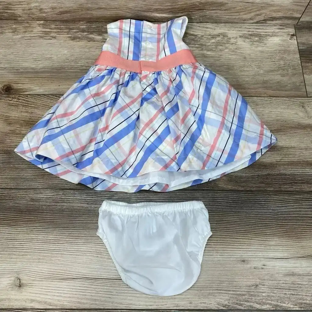 Top view of Carter’s 2pc plaid dress and bloomers in size 3m, with blue and pink plaid and white bloomers on wood floor