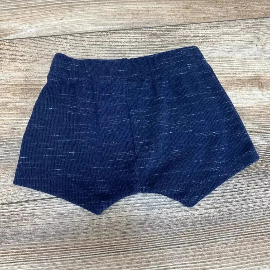 Front view of Seed Heritage baby shorts in blue, size 3-6 months, showing elastic waistband and cuffed legs on white background