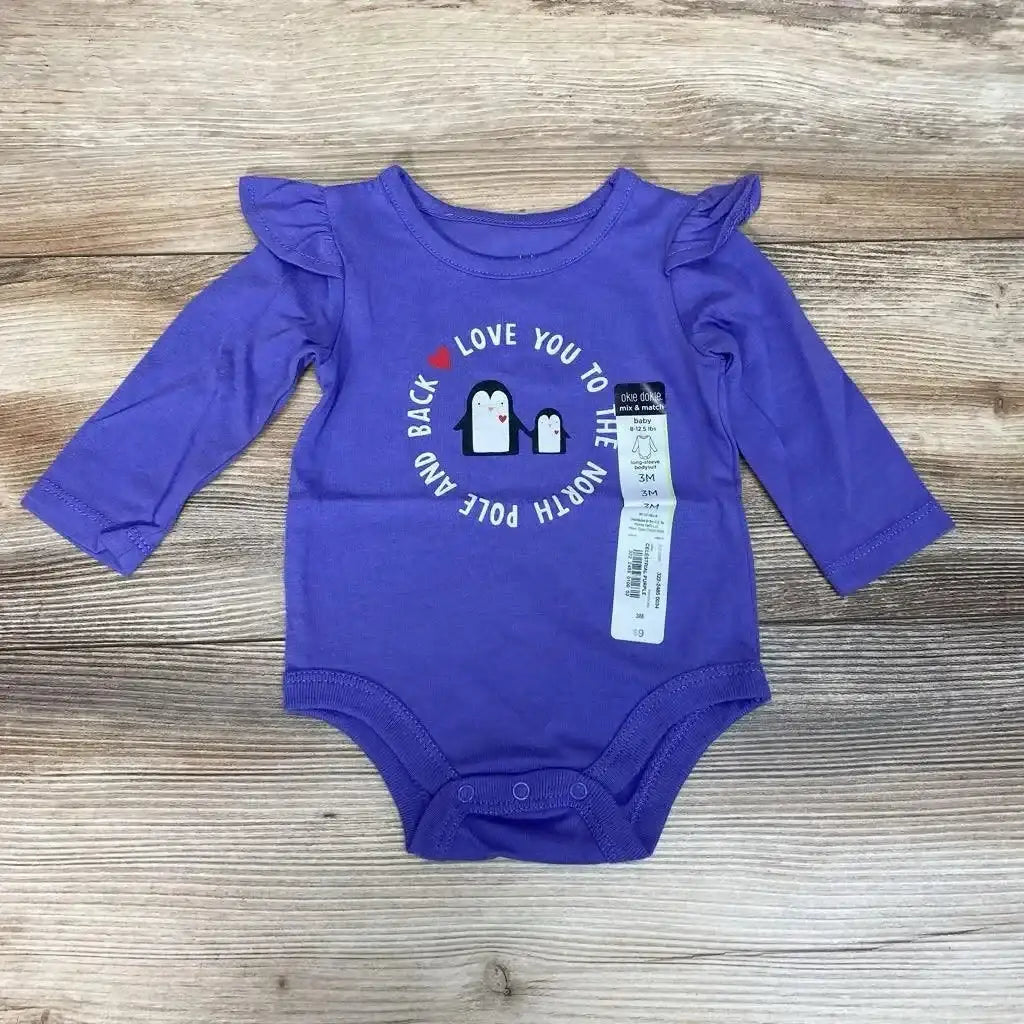 Front view of NEW Okie Dokie Long Sleeve Bodysuit sz 3m with purple fabric, ruffled shoulders, and penguin print
