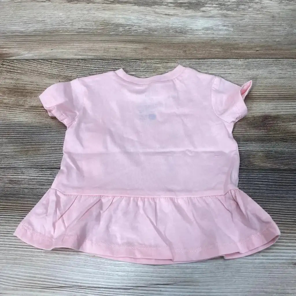 Front view of NEW Okie Dokie Dad’s Little Crawler Peplum Shirt sz 3m showcasing pink color and peplum hem on wood background