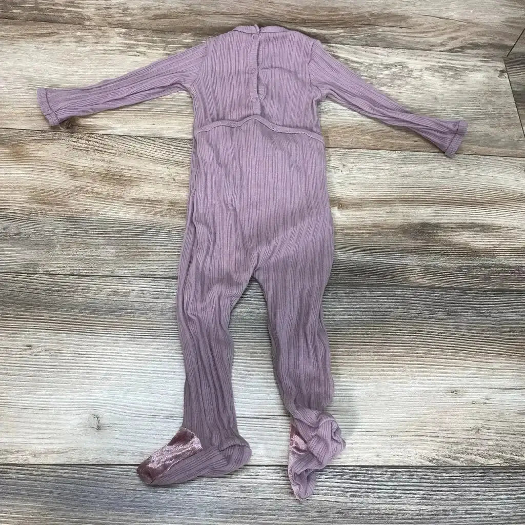 Front view of Hanna Kay Ruffle Footie sz 9m showcasing lavender ribbed fabric, long sleeves, and covered feet on a wood-grain background