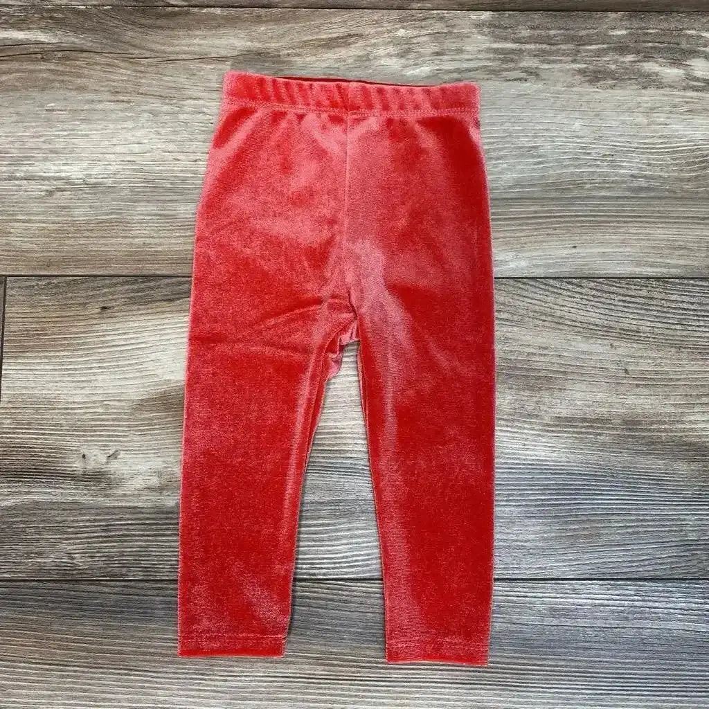 Front view of Okie Dokie Velour Leggings sz 6m showcasing red velour fabric and elastic waistband on a wood floor