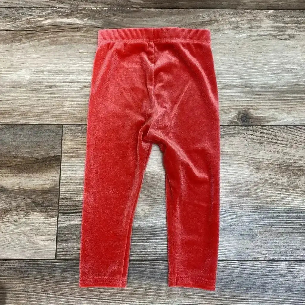 Front view of Okie Dokie Velour Leggings sz 6m showcasing red velour fabric and elastic waistband on a wood floor