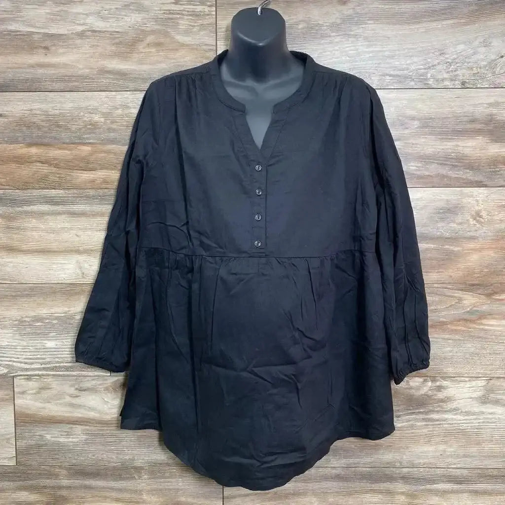 Front view of black Isabel maternity top, XL, with empire waist and button front on mannequin against wood background
