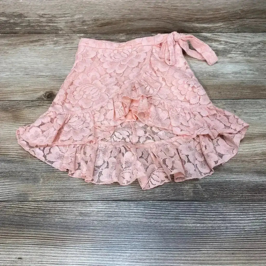 Top view of Bailey’s Blossoms Lace Skirt sz 12-18M with pink floral lace, tie waist, and ruffled hem on wood