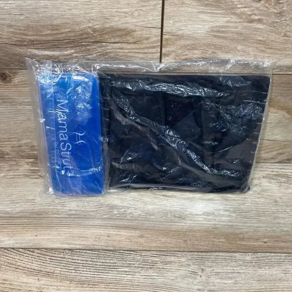 Front view of folded black Mama Strut postpartum support brace in clear plastic with blue Mama Strut pouch on wood floor