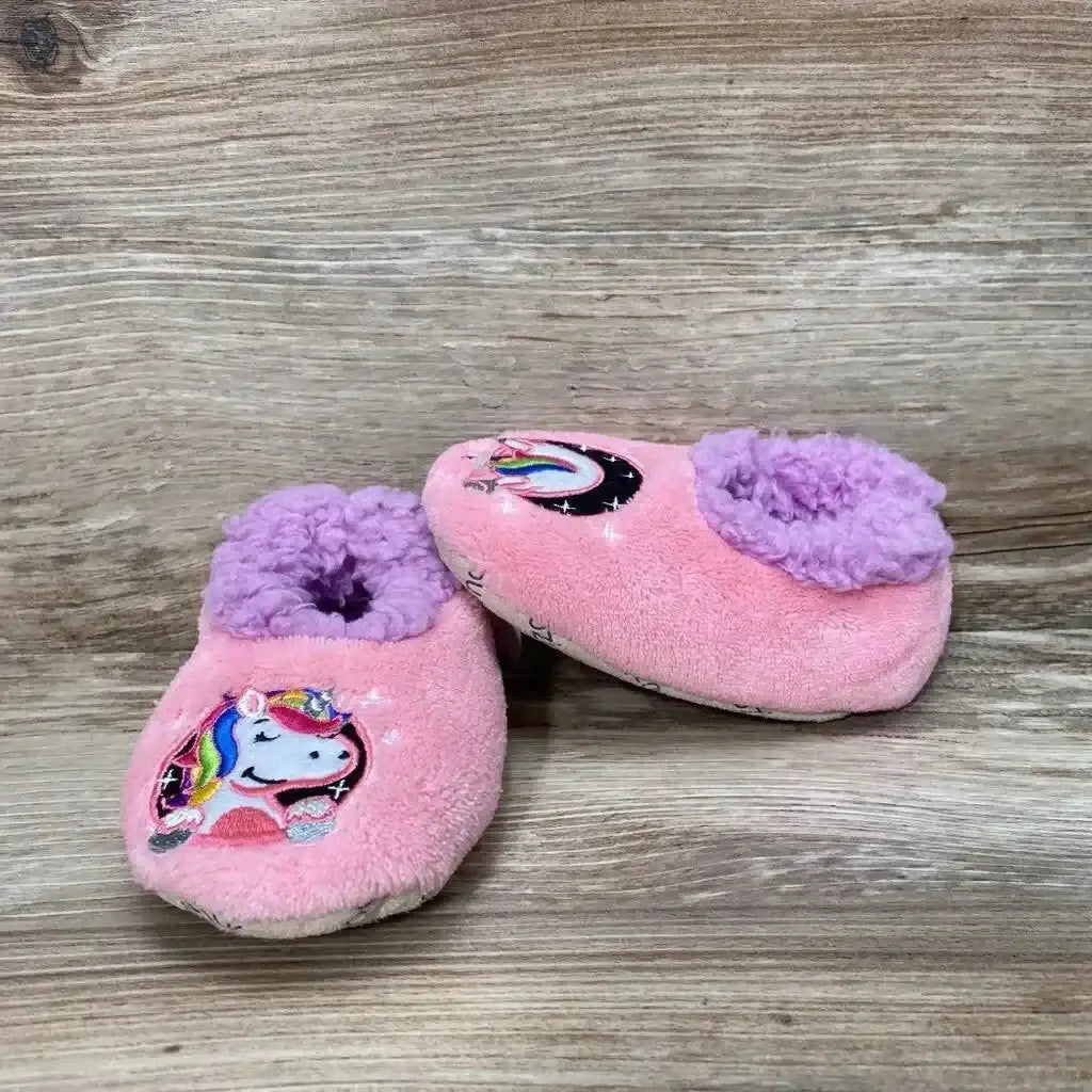 Front and side view of pink Snoozies Patch Pals slippers, size 5/6, showing unicorn patch and purple lining on wood background