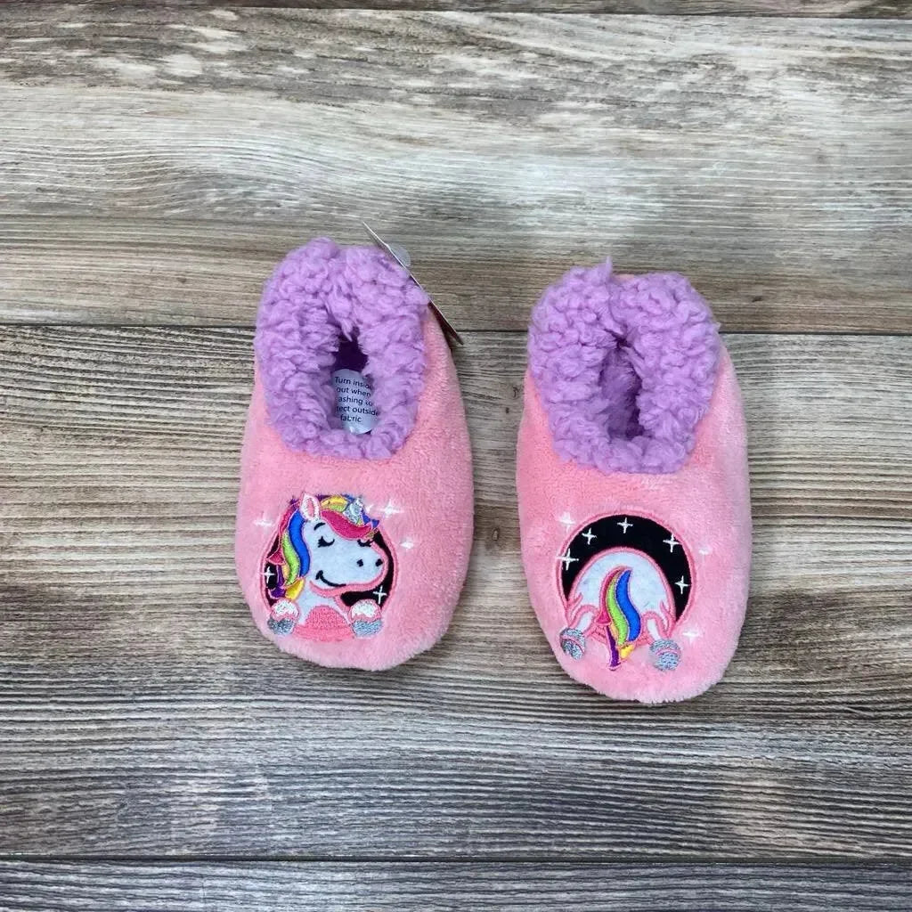 Top-down view of pink Snoozies Patch Pals toddler slippers, size 5/6, showcasing unicorn patch designs and purple fleece lining on wood background